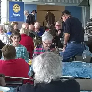 members at bbq lunch on verandah
